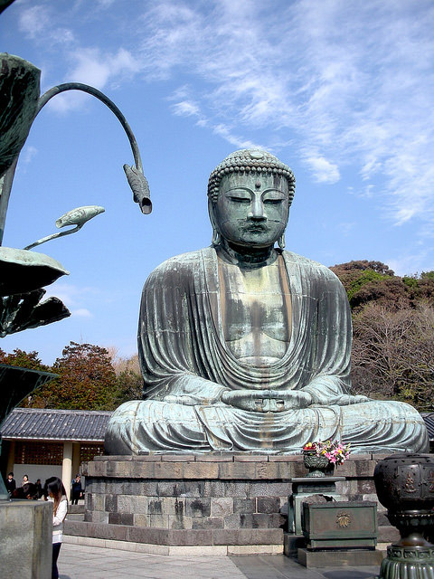 The Great Buddha at Kamakura with floral offerings. Image courtesy of the author