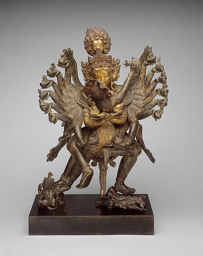Deity Hevajra with consort Nairatmya. Gilt bronze, Nepal, 17th century. Image courtesy of the Art Institute of Chicago. Note the deity has 16 arms and four legs; the dakini has two arms and two legs. Shining gold pierces through the central column of energy chakras. The multiple arms can be seen as a four-armed deity dancing