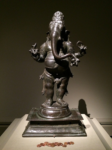 Even in the Met, visitors leave devotional gifts before a statue of the Hindu deity Ganesh. Image courtesy of the author